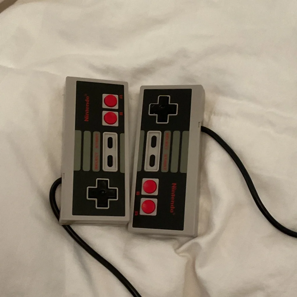 Nintendo Console in Gray and Black with controllers and gun and cords